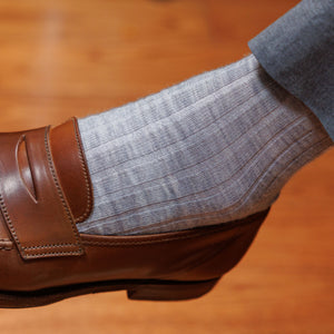 man wearing light grey merino wool dress socks with grey slacks and brown penny loafers