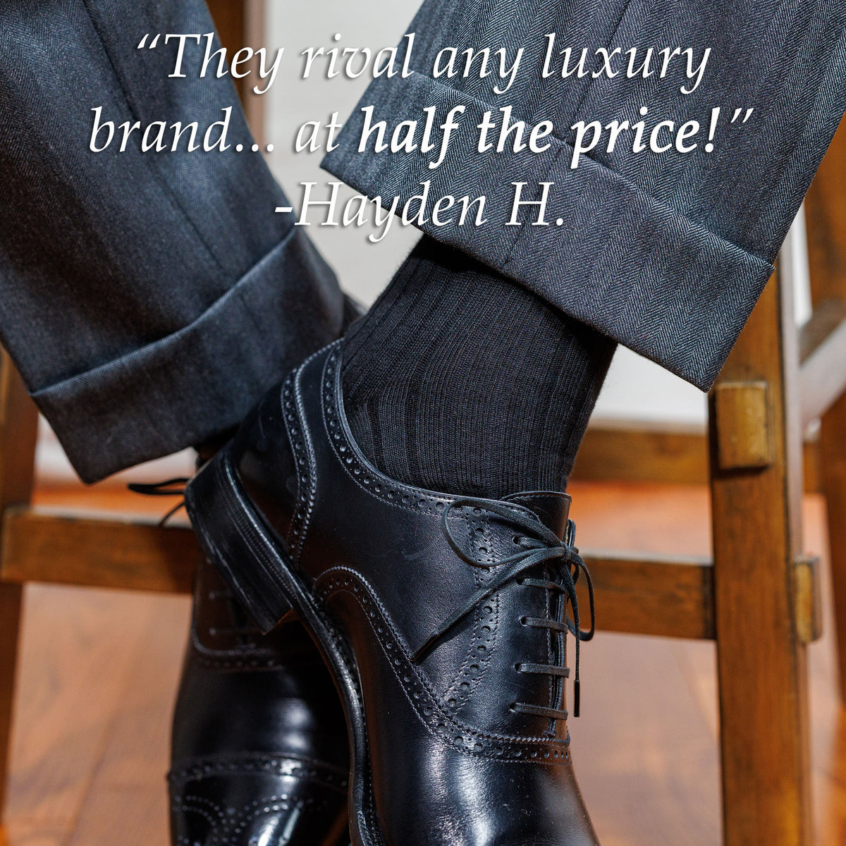 black cotton dress socks worn with professional attire by man sitting on stool