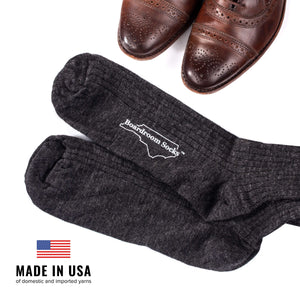 flat laid socks and pair of shoes with made in usa of domestic and imported yarns text overlay 