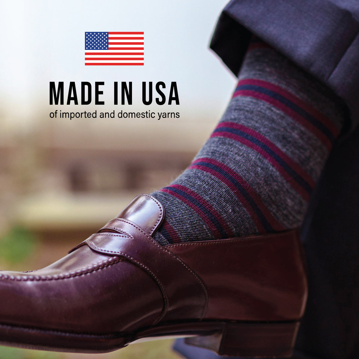 close up image of a mans leg wearing loafers and Burgundy and Navy Stripes on Grey Merino Wool Mid-Calf Dress Socks