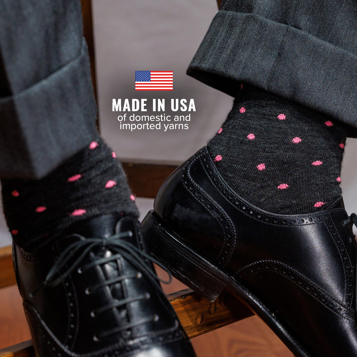 Black dress shoes with dark grey polka dot dress socks and text &#39;Made in USA&#39;