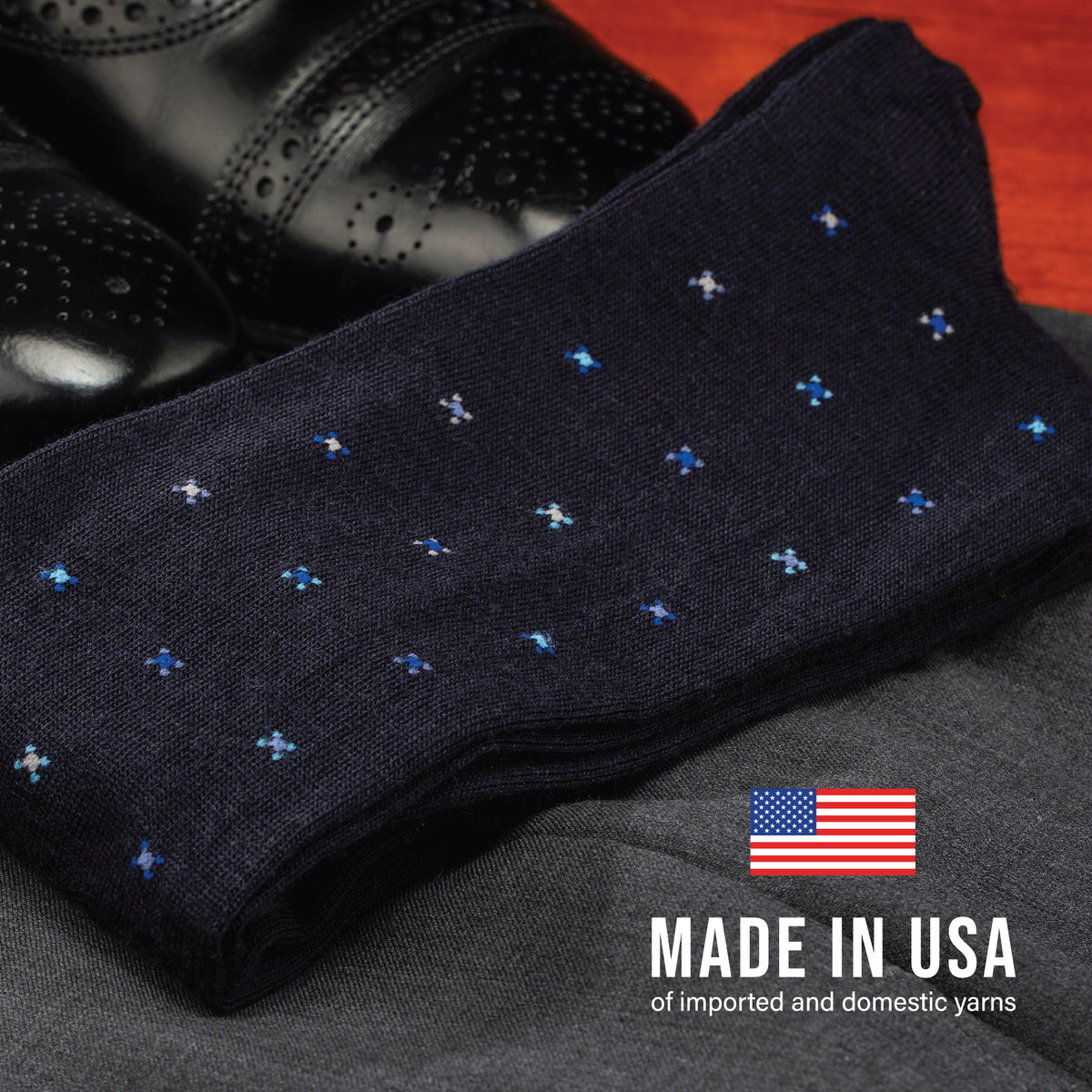 flay laying pair of Navy Geometric Merino Wool Over the Calf Dress Socks on clothing