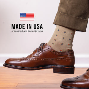 man's right foot wearing over the calf khaki dress socks with made in the usa text overlay