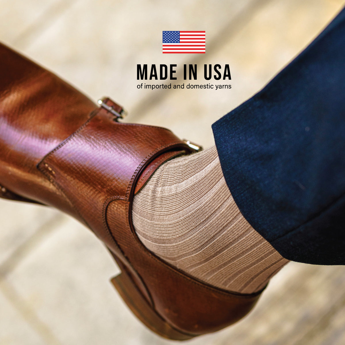 close up image of person wearing Khaki Cotton Over the Calf Dress Socks with a text overlay of "made in usa"