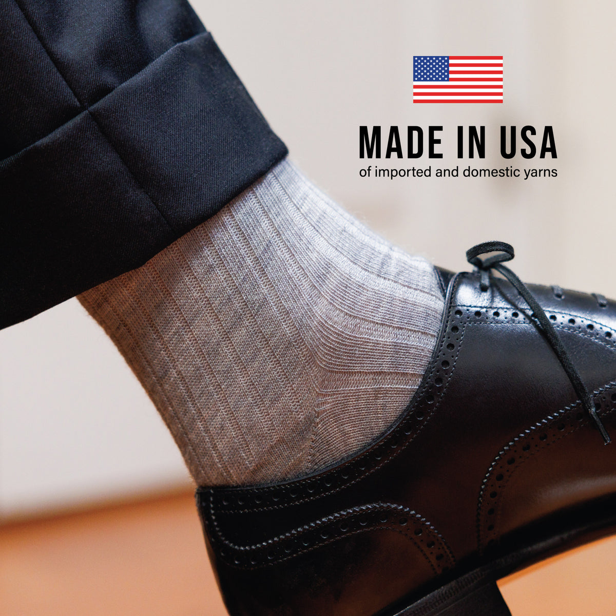 close up of light grey heather merino wool dress socks with made in usa text overlay