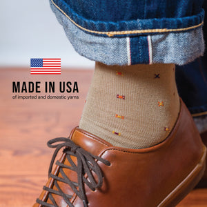 man wearing jeans, brown lace up shoes and a khaki geometric pattern cotton dress sock with made in usa text overlay