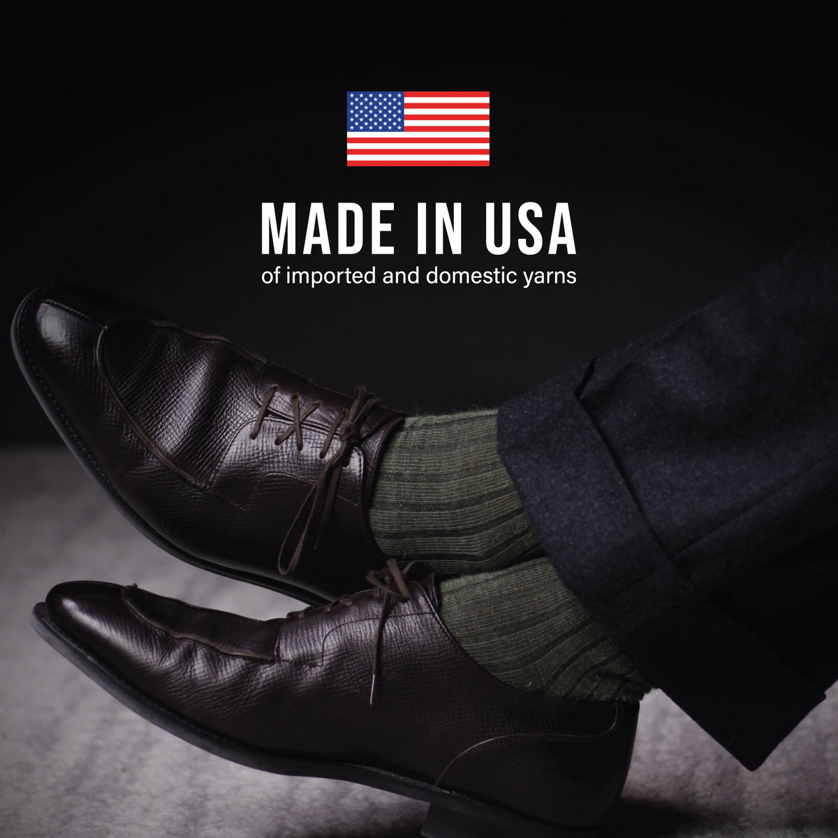 man crossing his legs wearing olive merino wool over the calf ribbed mens dress socks with made in usa text overlay