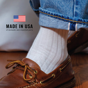 man wearing jeans, casual shoes and white cotton over the calf length dress socks