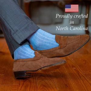man crossing ankles wearing sky blue american made dress socks