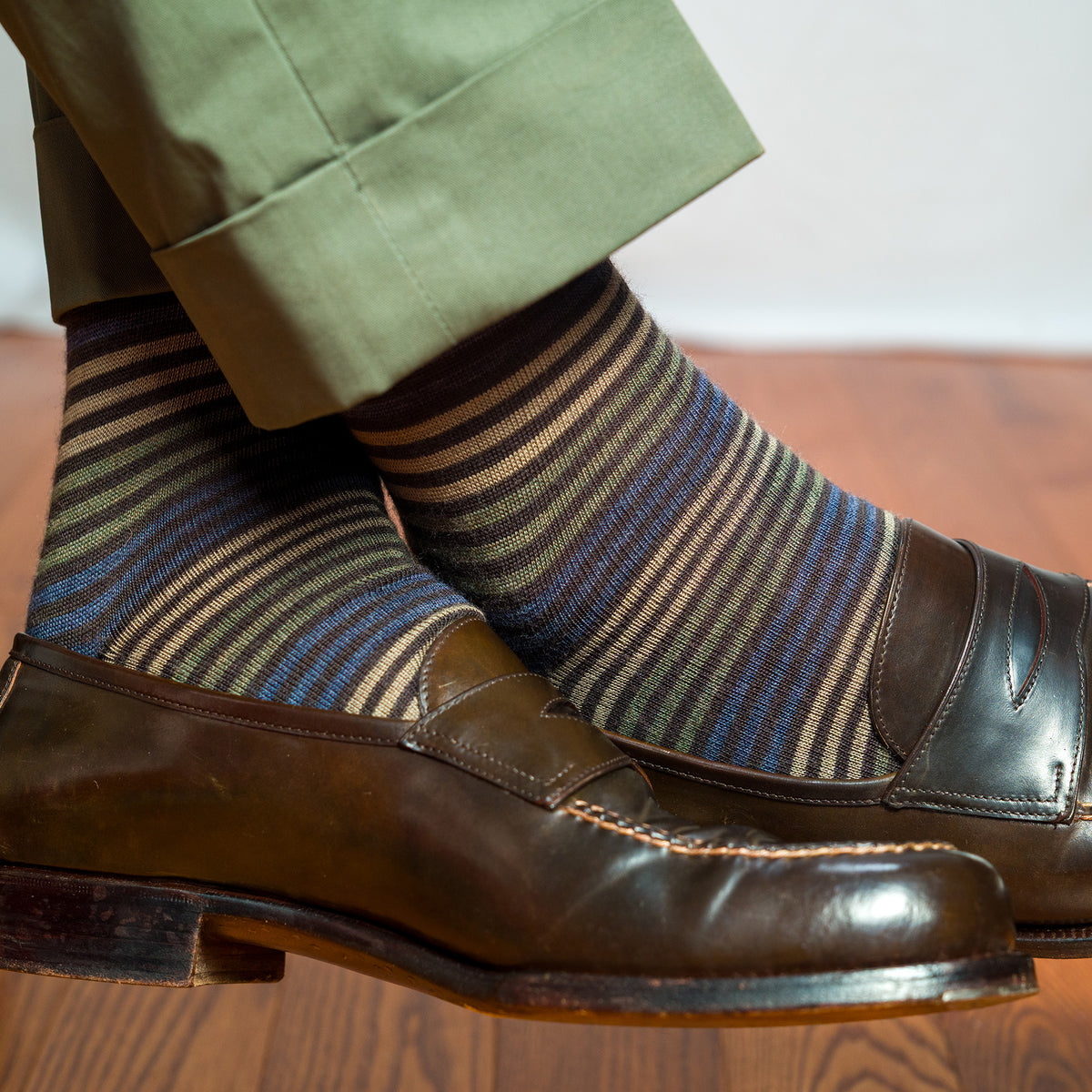 striped dress socks with brown and blue pattern worn with brown penny loafers