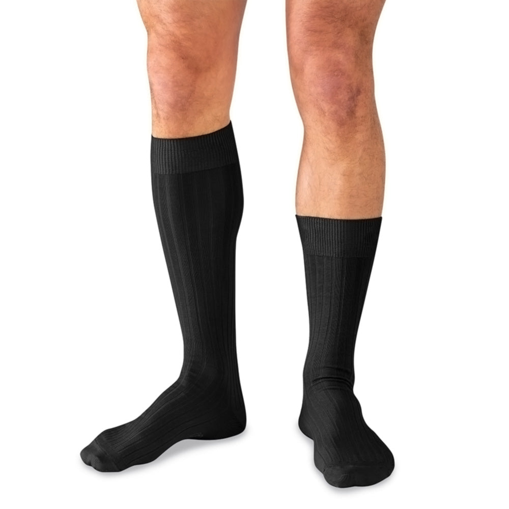 A man wearing one black ribbed knee-high sock and one mid-calf length black sock, shown against a plain white background.