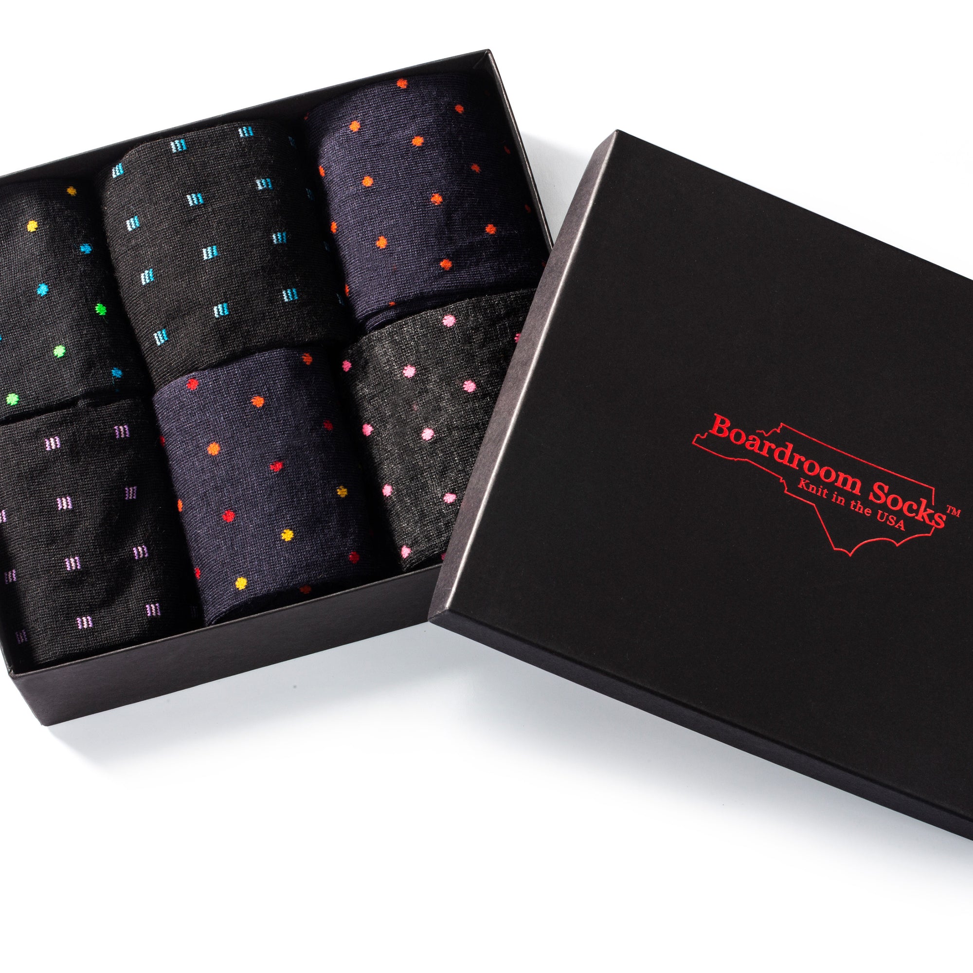 opened gift box showing six pairs of colorful patterned dress socks for men