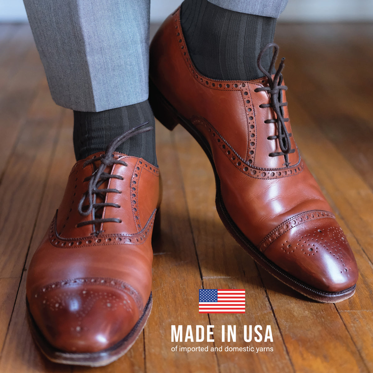 man standing on a hardwood floor wearing nice shoes, pants and Grey Cotton Mid Calf Dress Socks