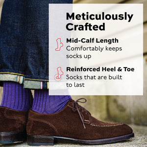 man standing wearing jeans, brown shoes and purple merino wool dress socks