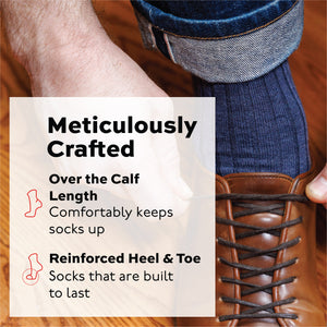 man tying brown shoes wearing jeans and denim merino wool ribbed dress socks