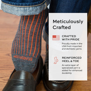 image of orange and grey shadow stripe dress socks worn with jeans and loafers and text overlay about craftsmanship