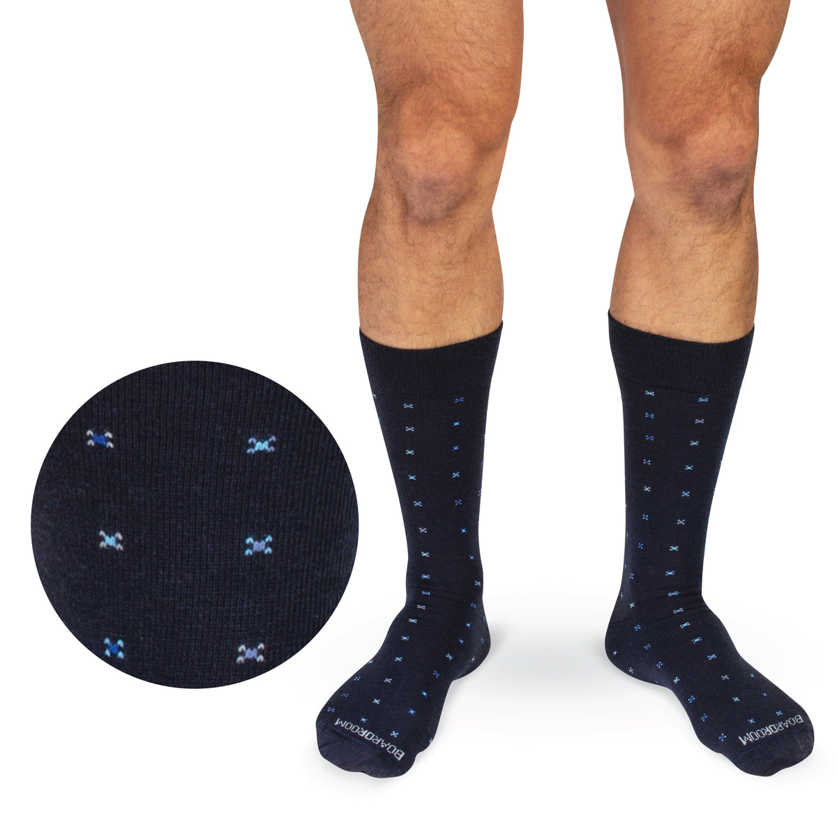 model standing wearing Navy Geometric Merino Wool Mid-Calf Dress Socks on a white backgournd