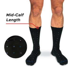 model wearing mid-calf length black cotton dress socks with geometric pattern on a white background