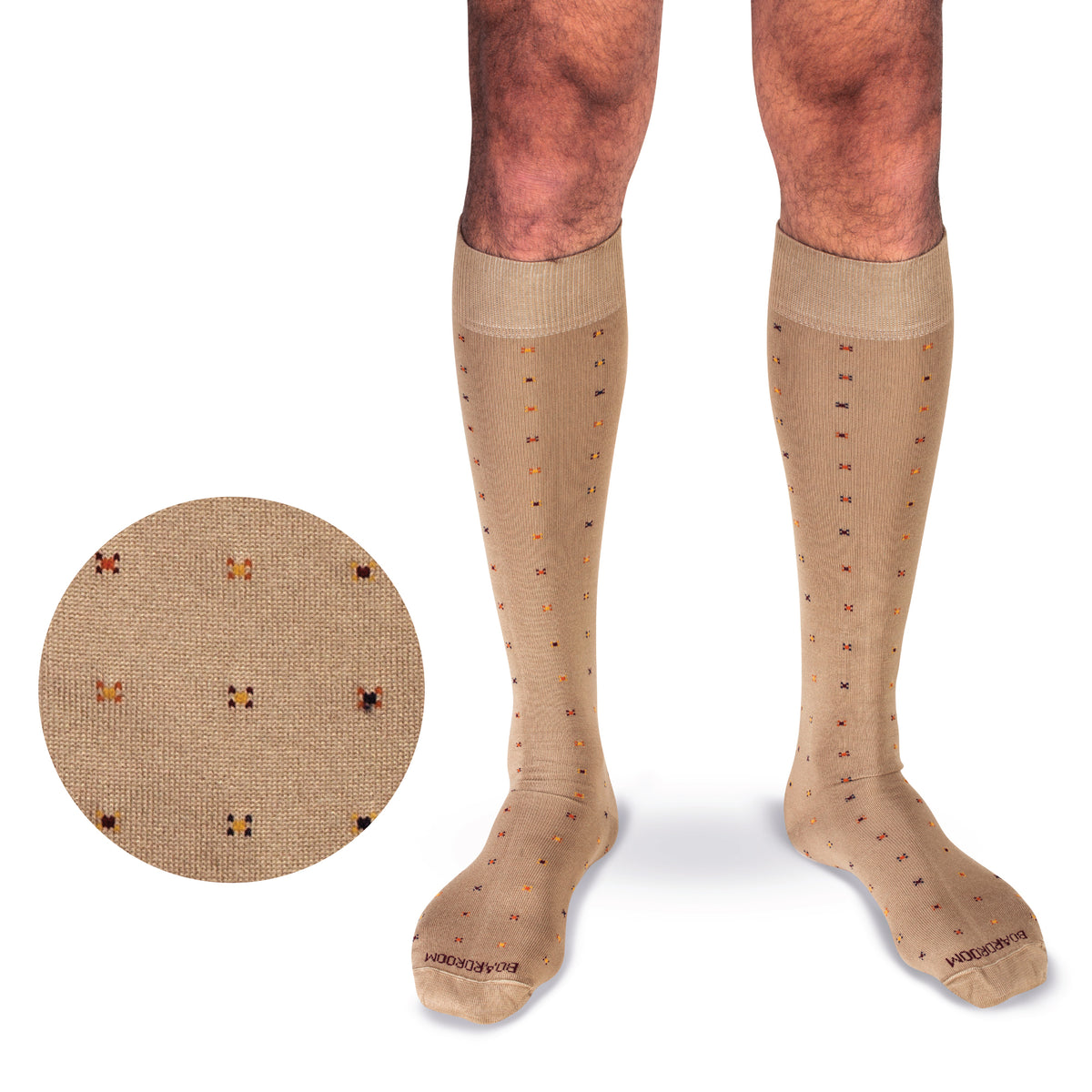 model wearing khaki over the calf cotton dress socks with a geometric pattern on a white background