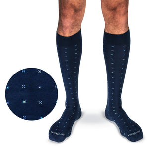 model wearing navy over the calf cotton dress socks with a geometric pattern with a white background