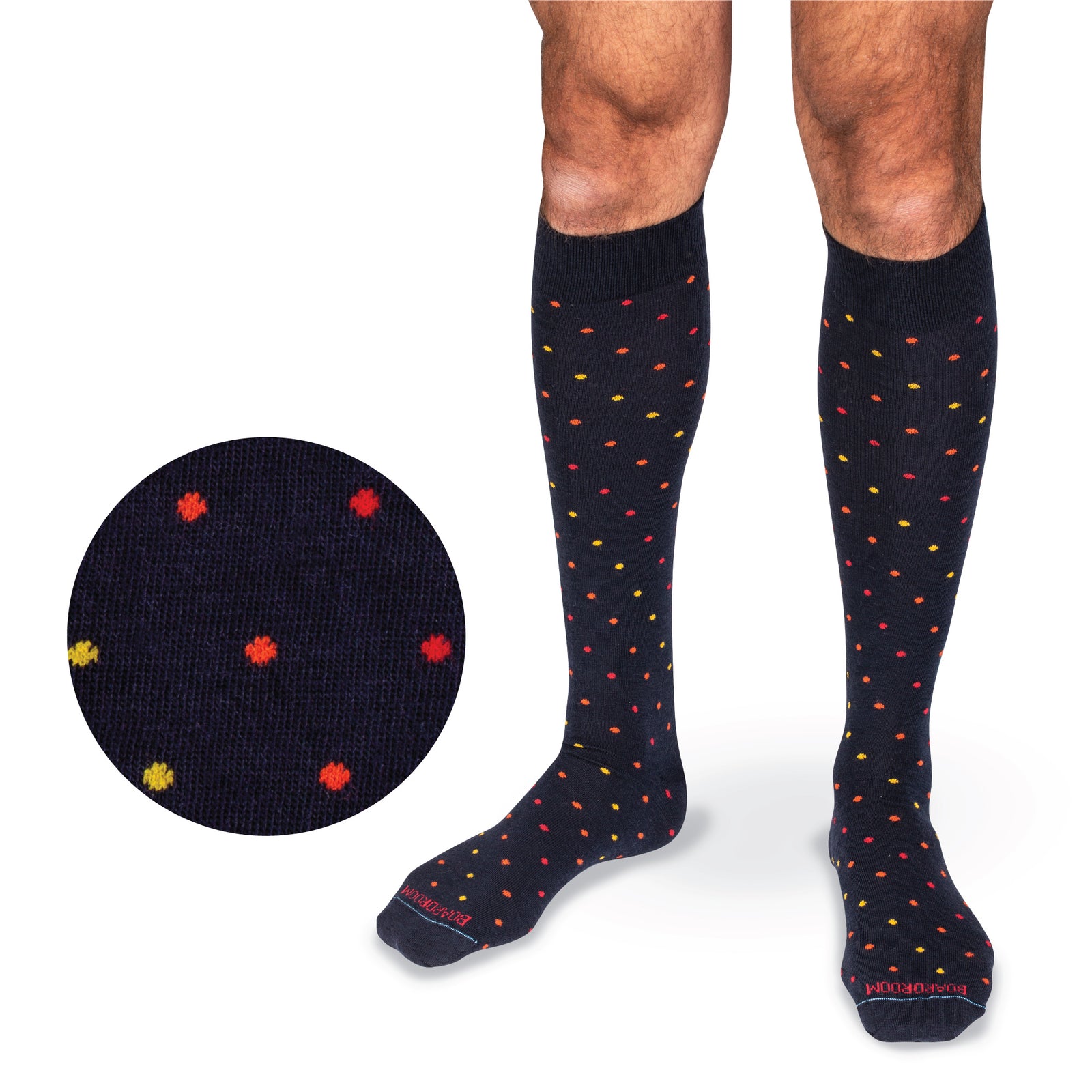 model's legs on a white background wearing over the calf merino wool navy socks with a tri-color dot pattern
