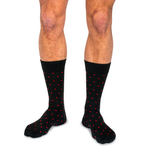 model wearing black dress socks decorated with bright red polka dots