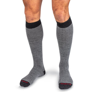 model wearing grey herringbone over the calf dress socks