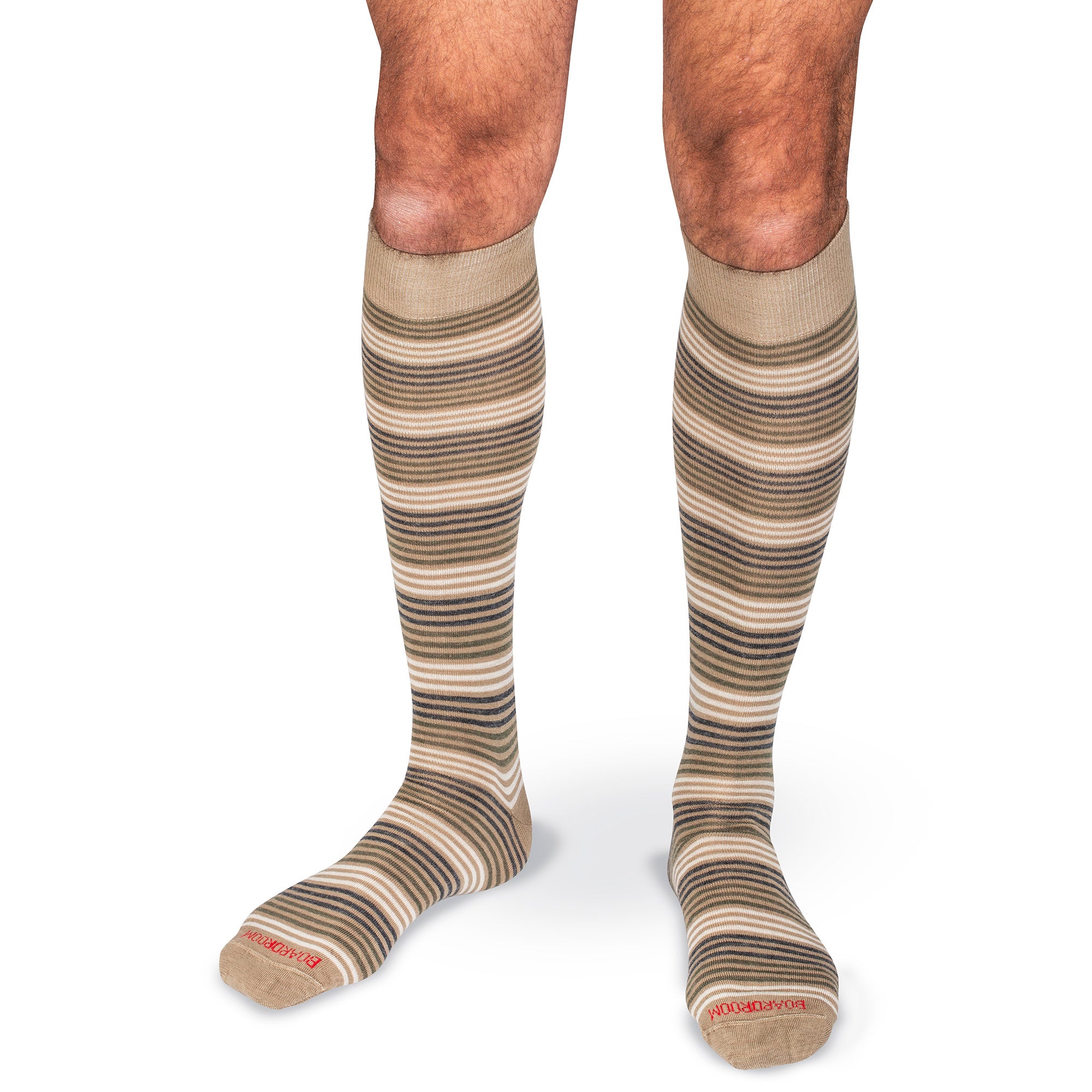 tan and olive striped knee-high dress socks worn by a model in front of a white background