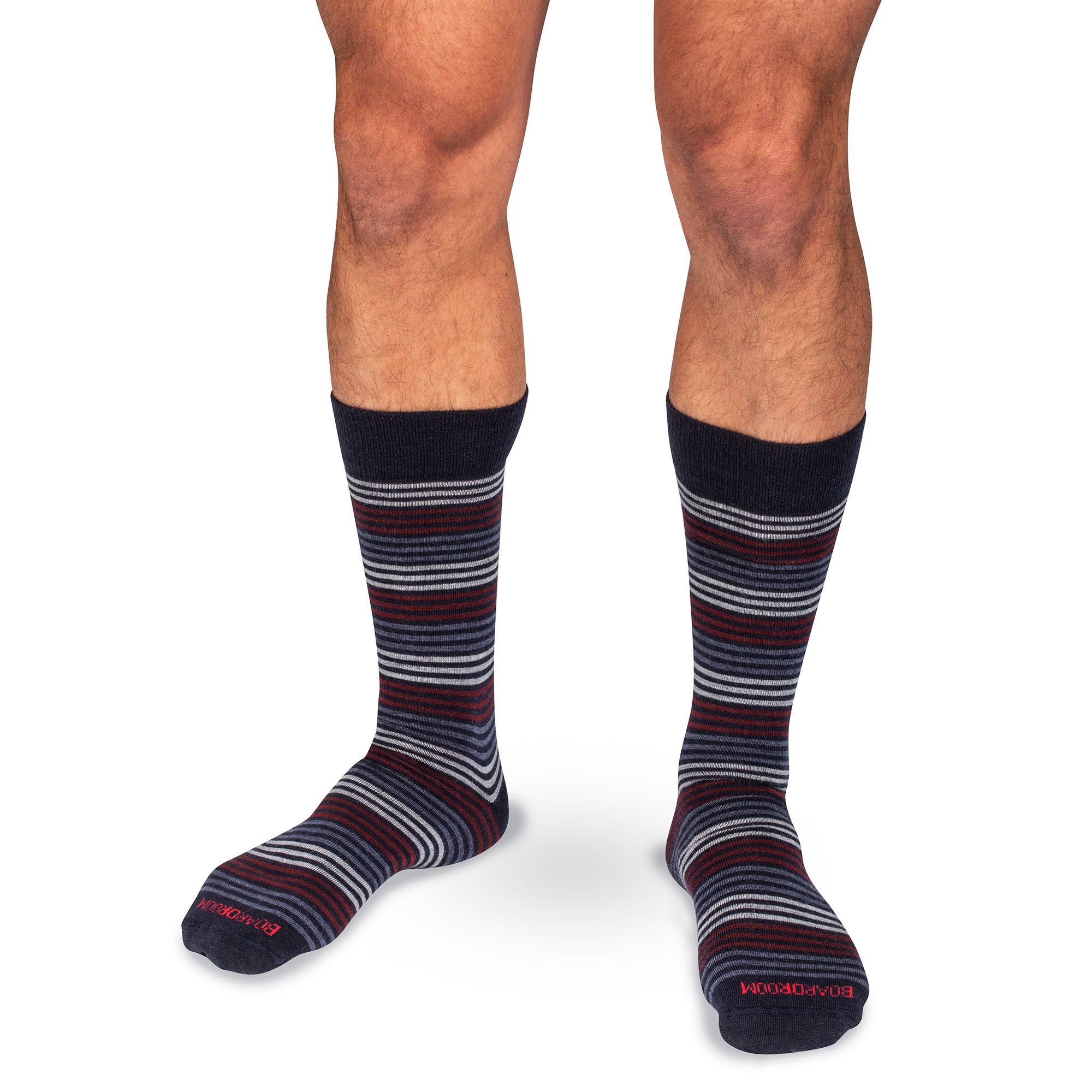 colorful striped mid-calf dress socks worn by a model on a white background