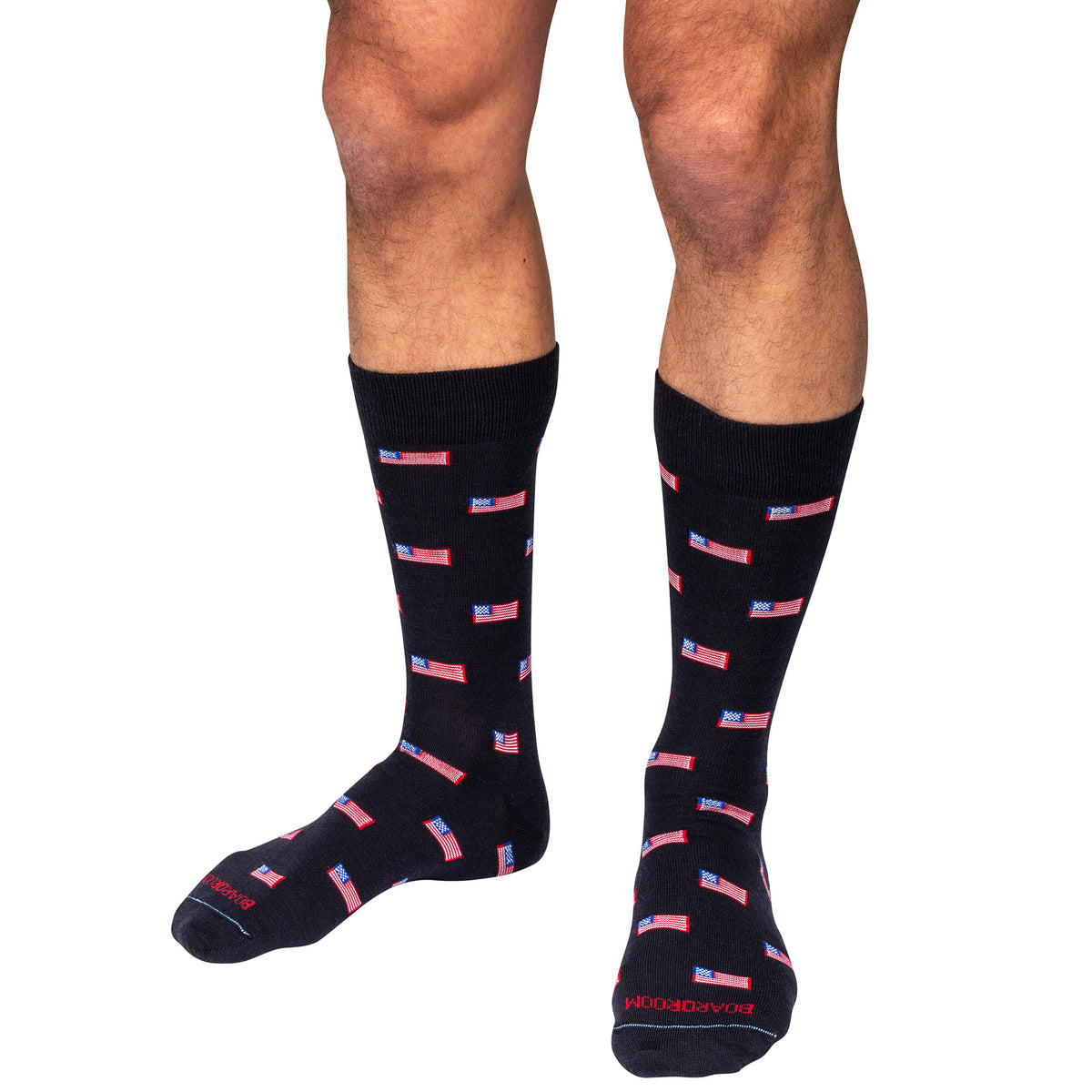model wearing mid-calf length merino wool dress socks decorated with small American flags