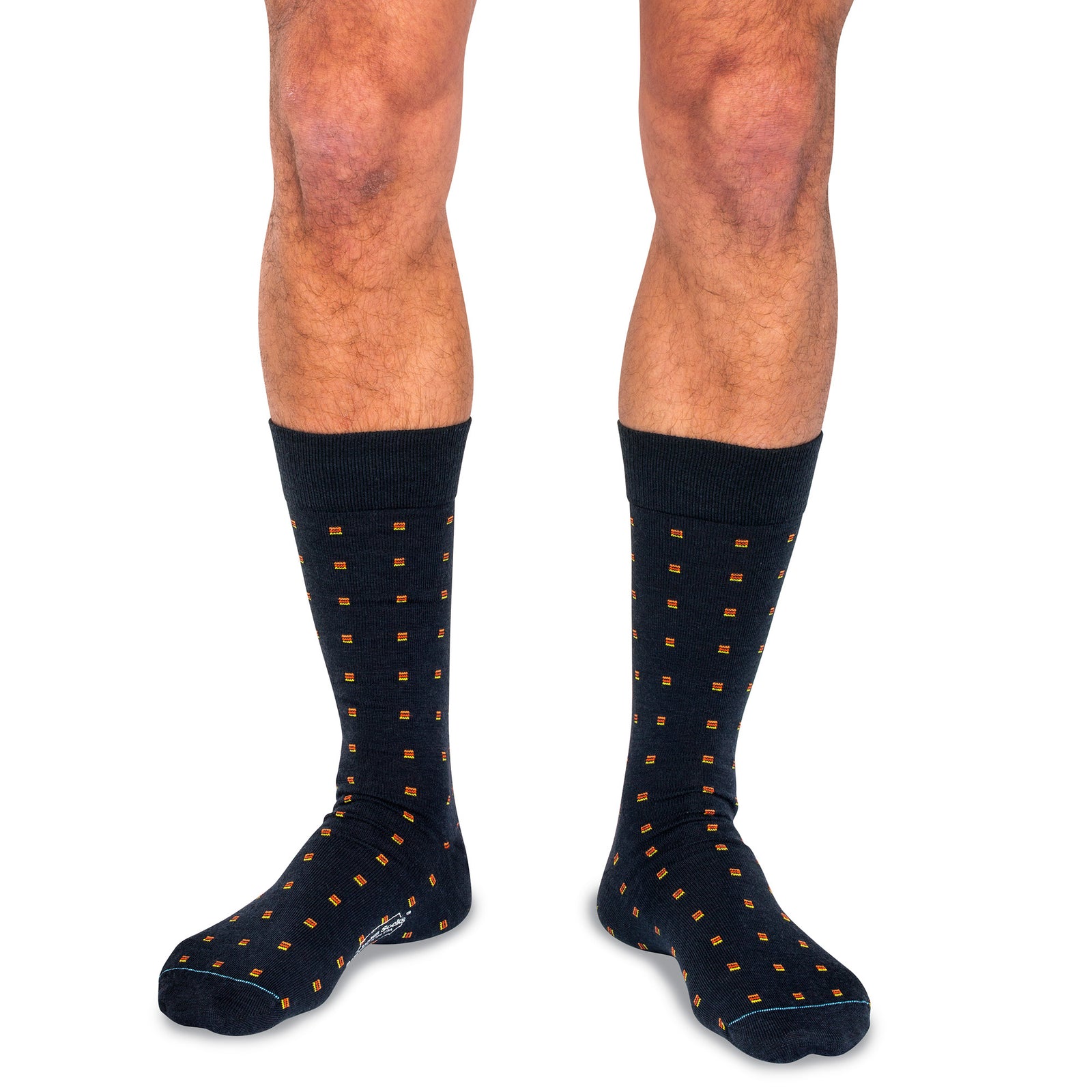 model wearing navy merino wool dress socks decorated with small orange lines