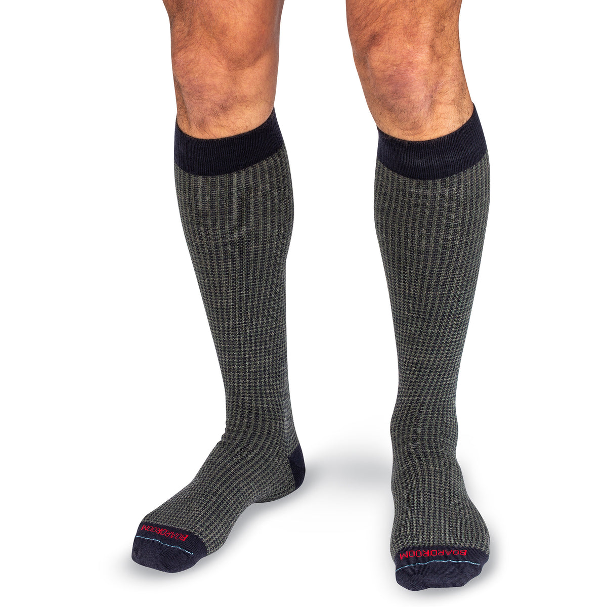 man wearing pair of olive and navy houndstooth over the calf dress socks