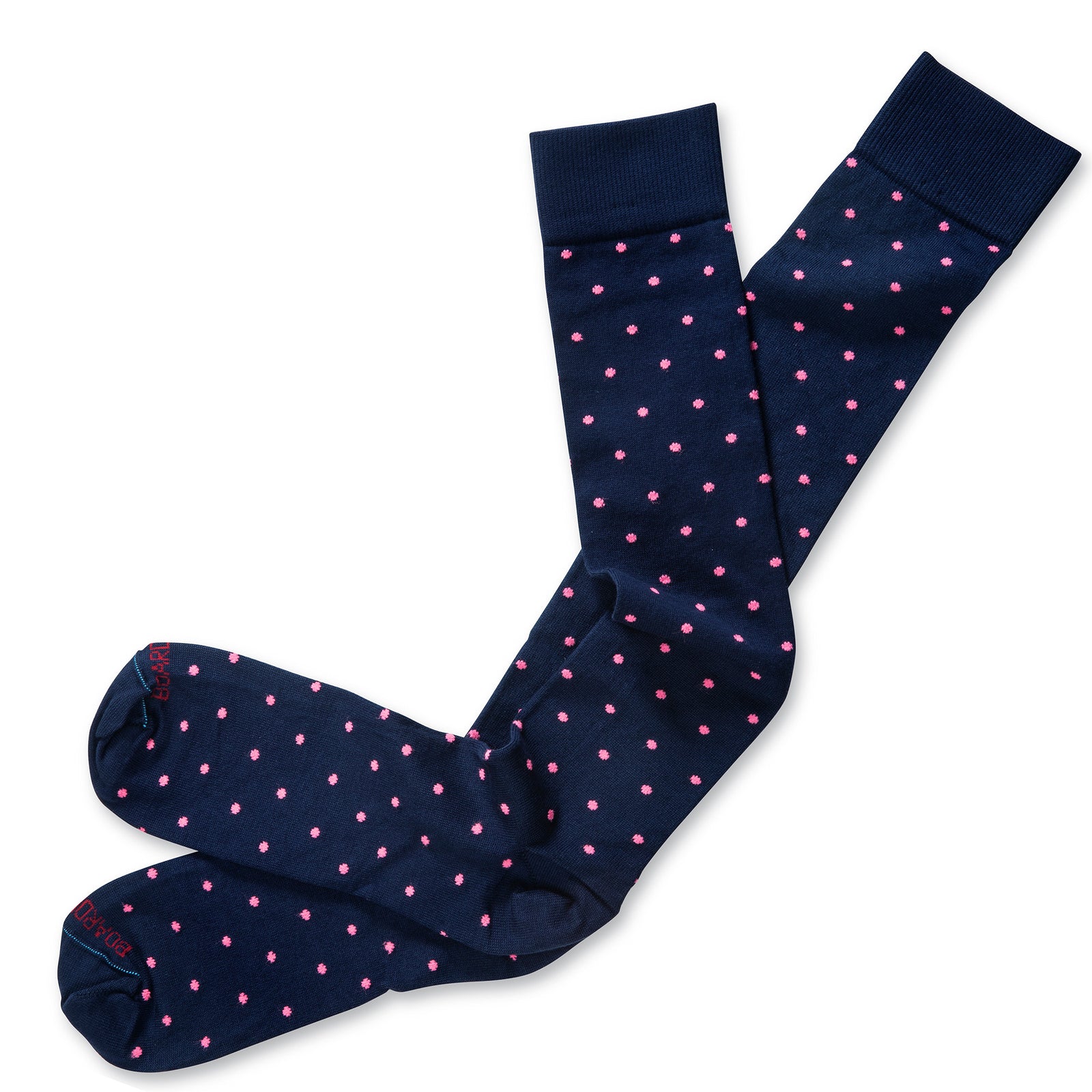 pair of navy cotton over the calf dress socks decorated with bright pink polka dots atop white table