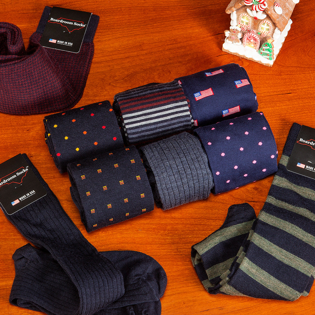 navy dress socks for the holidays from Boardroom Socks atop cherry tabletop