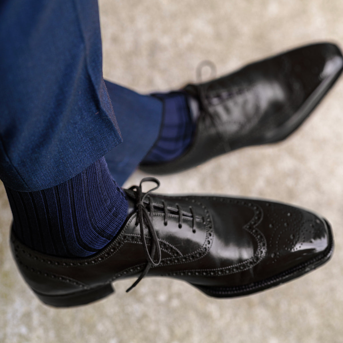 person wearing Navy Cotton Mid Calf Dress Socks with navy pants and black dress shoes