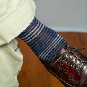 close-up of navy striped dress sock worn with brown wingtip dress shoes and khaki pants