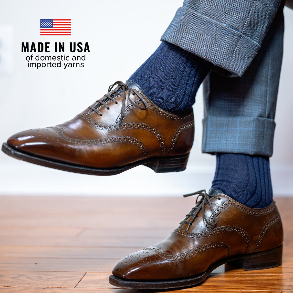 man wearing navy merino wool dress socks crossing legs