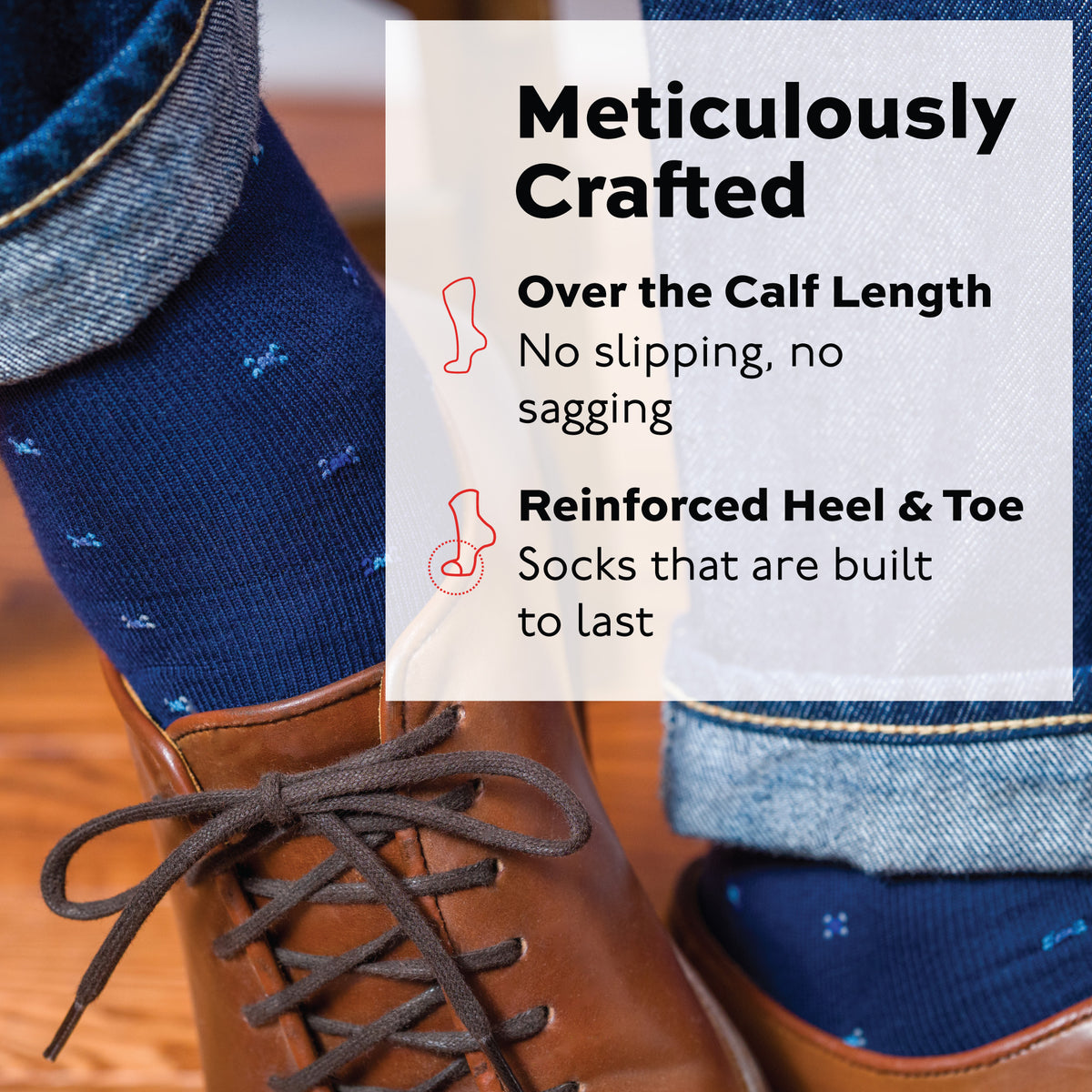 detailed image of a person wearing jeans, brown laced shoes and navy cotton dress socks with a geometric pattern