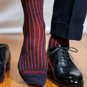 navy and red shadow stripe dress socks worn with navy suit and black oxfords