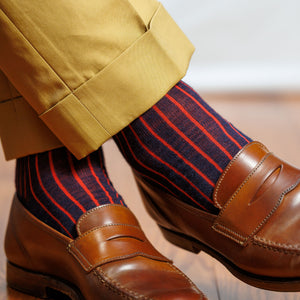 navy and red vertical striped dress socks with tan slacks and brown penny loafers