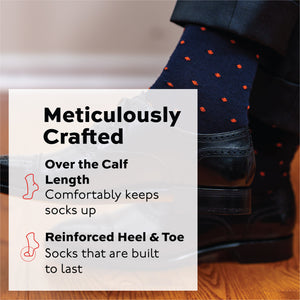 man crossing his legs wearing navy merino wool dress socks with orange dots with meticulously crafted text overlay
