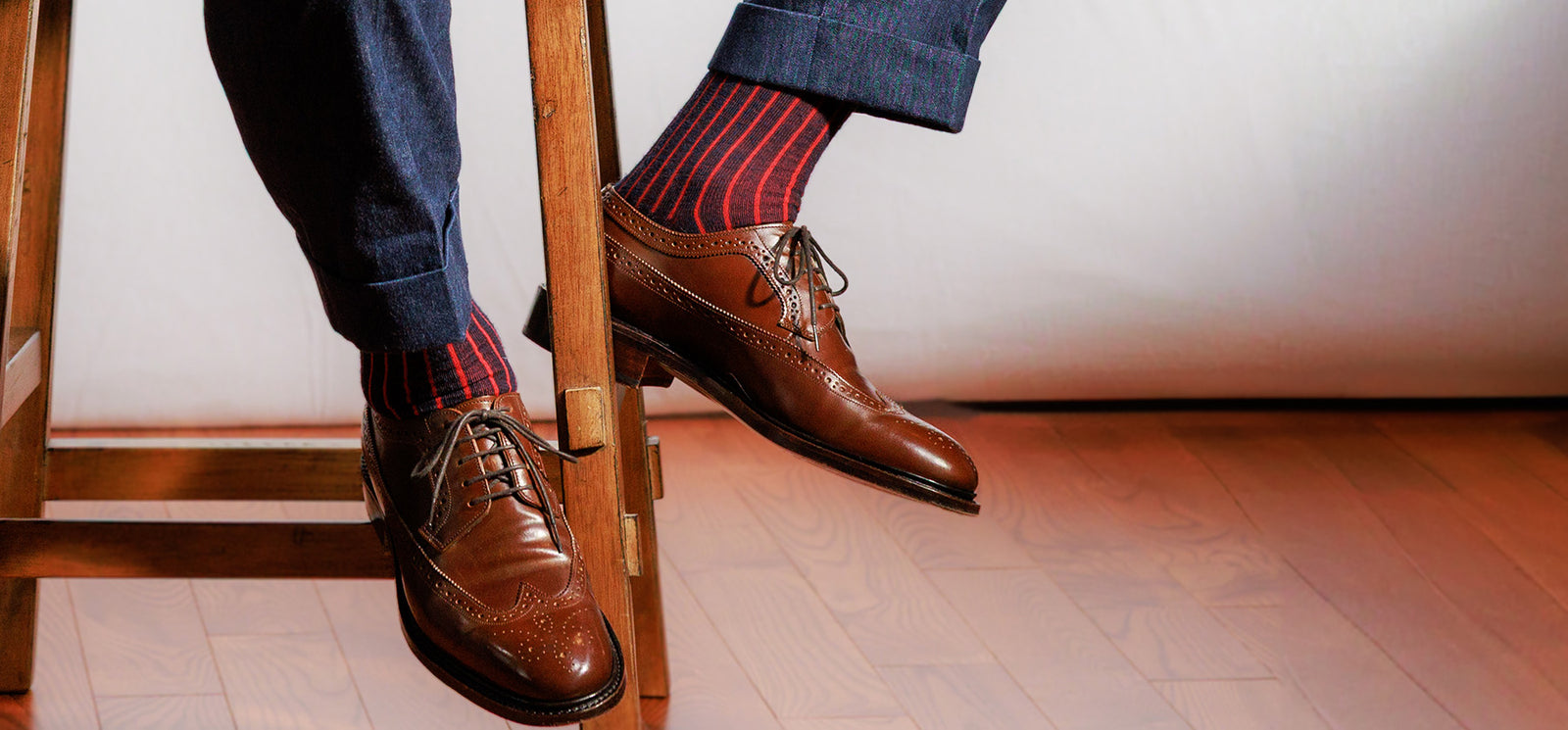 navy wool dress socks with red vertical stripes worn by professional man