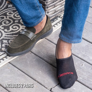 man sitting outside wearing  premium merino wool no-show socks in black