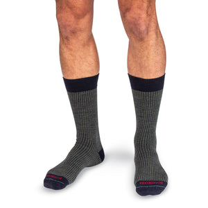 model wearing olive and navy houndstooth dress socks