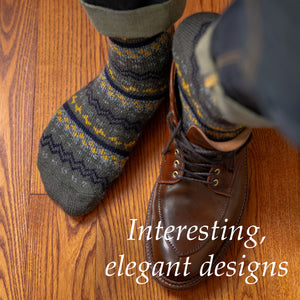 man wearing olive green Fair Isle boot socks with jeans and dress boots