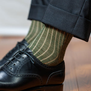 man wearing olive and tan shadow stripe dress socks with charcoal suit and black oxfords