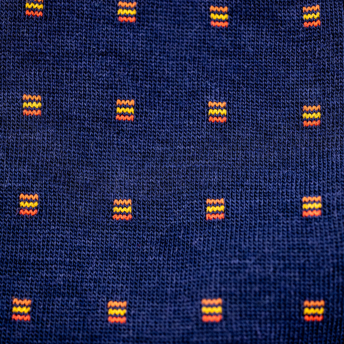 photo showing detail and texture on a pair of navy and orange merino wool dress socks