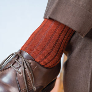 close up of Burnt Orange Merino Wool Mid Calf Dress Socks worn with brown pants and shoes