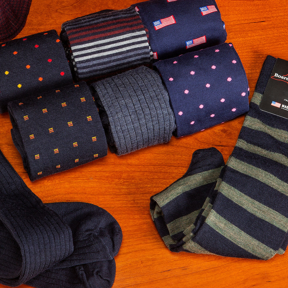 collection of colorful and stylish men's dress socks elegantly displayed atop a wooden table