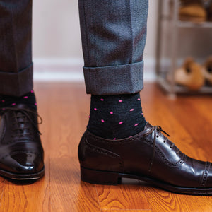 person standing wearing grey slacks, black oxfords and over the calf merino wool dress socks